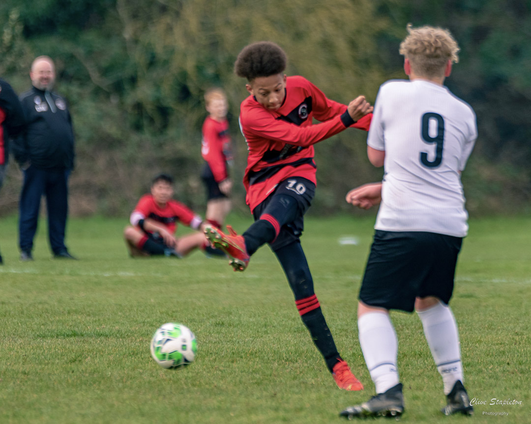 Young footballer striking the ball